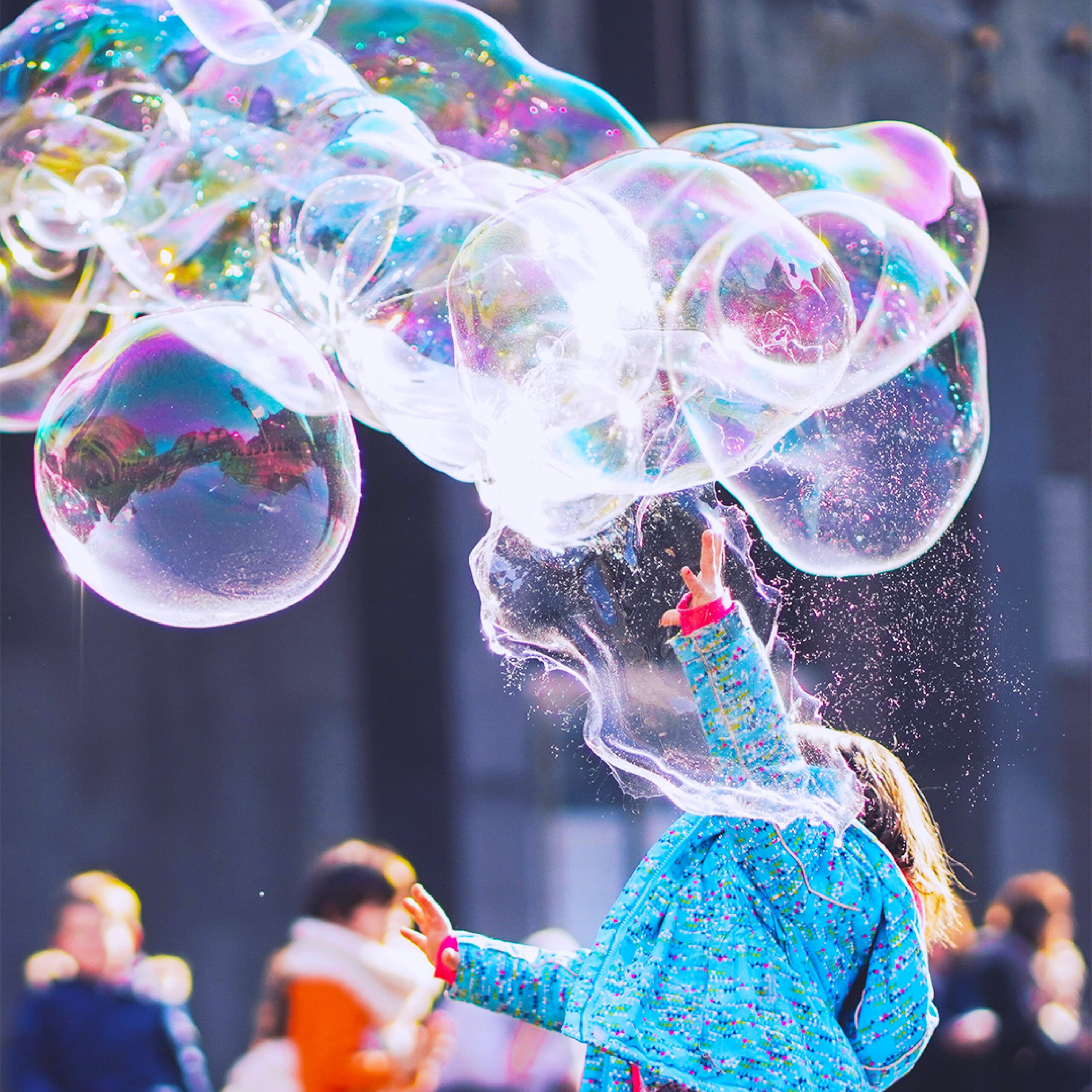 child playing with bubbles