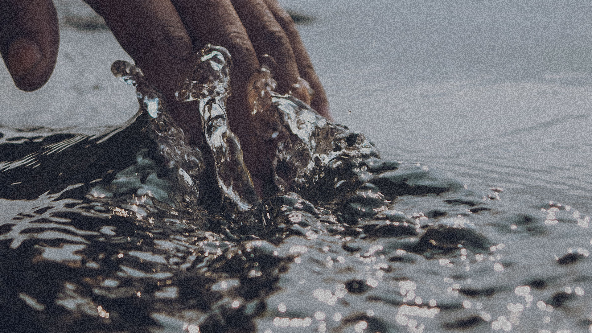 Hand touching water